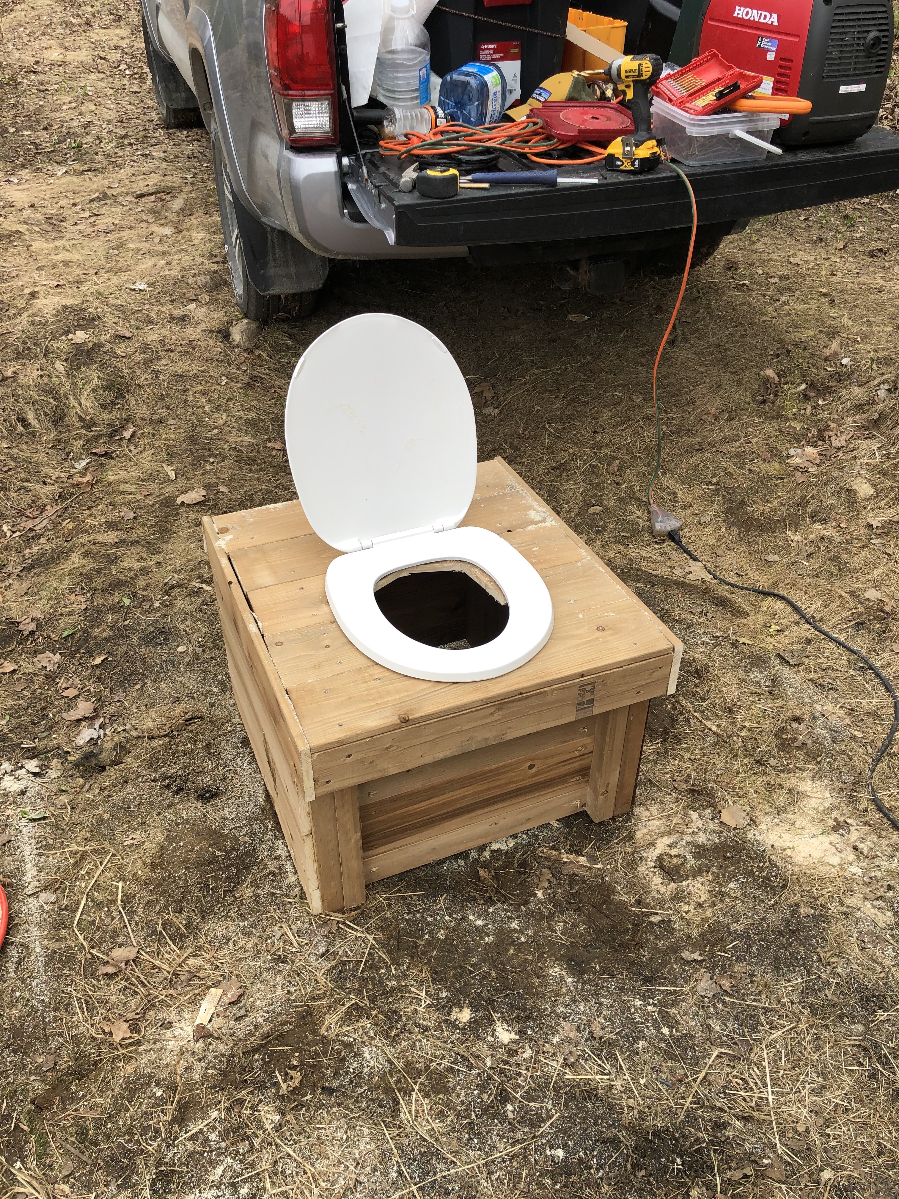 A thunderbox, or a minimal outhouse, consisting of a wooden box with a hole cut to put a toilet seat on