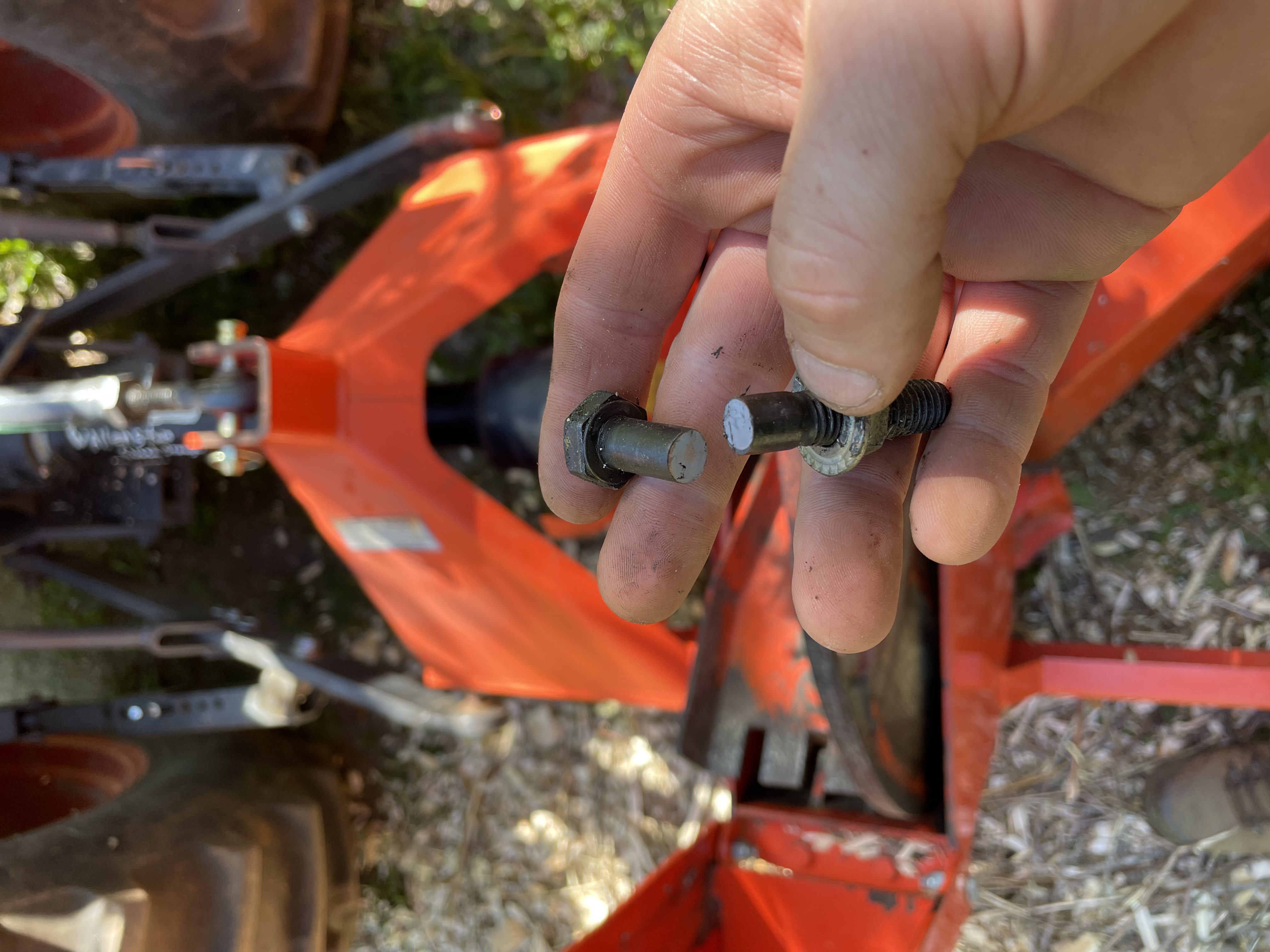 A bolt, broken in two, in my hand. It’s a shear pin from the wood chipper.