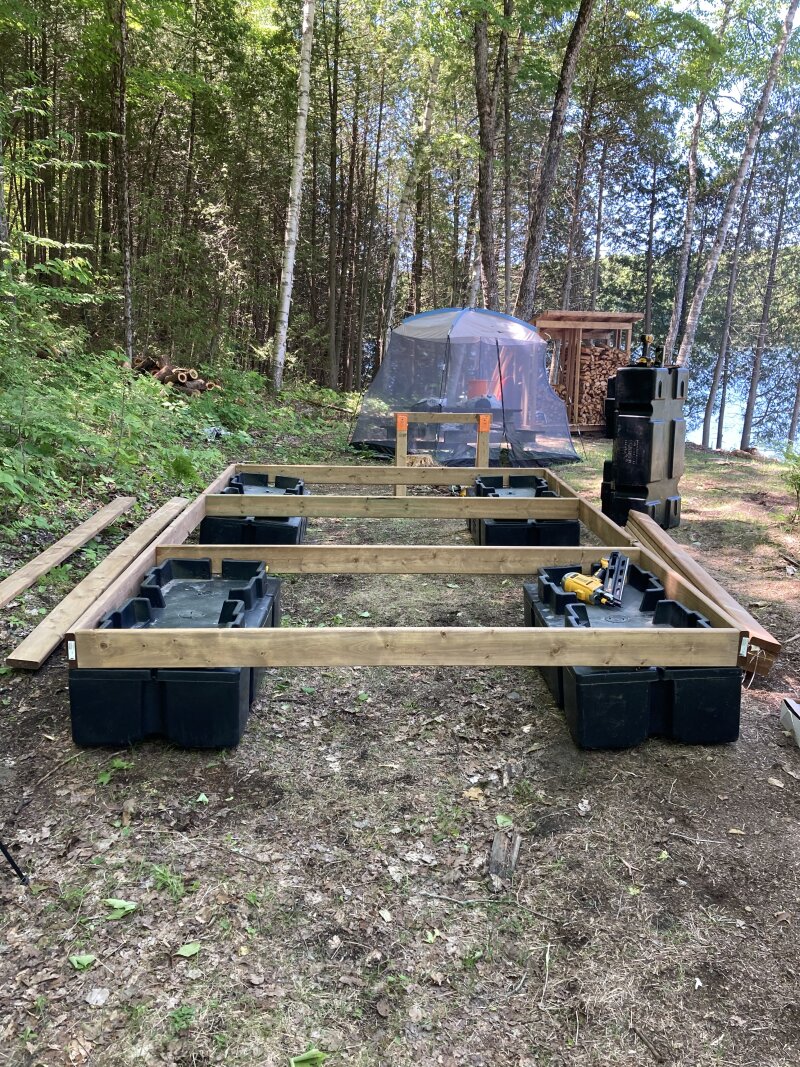 A dock frame coming together on the flattest piece of ground around, with dock floats bolted directly inside the frame.