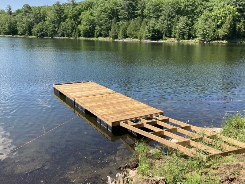 Dock nearing completion, with deck boards on both water sections, only the ramp remaining