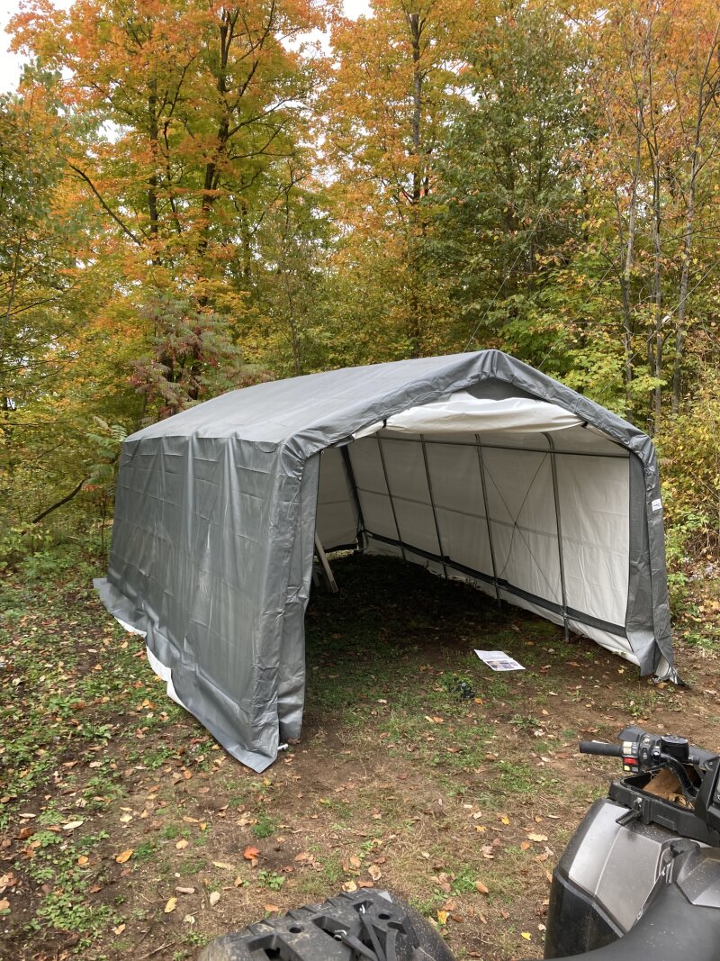 A 12 x 20 foot vinyl carport almost completely assembled