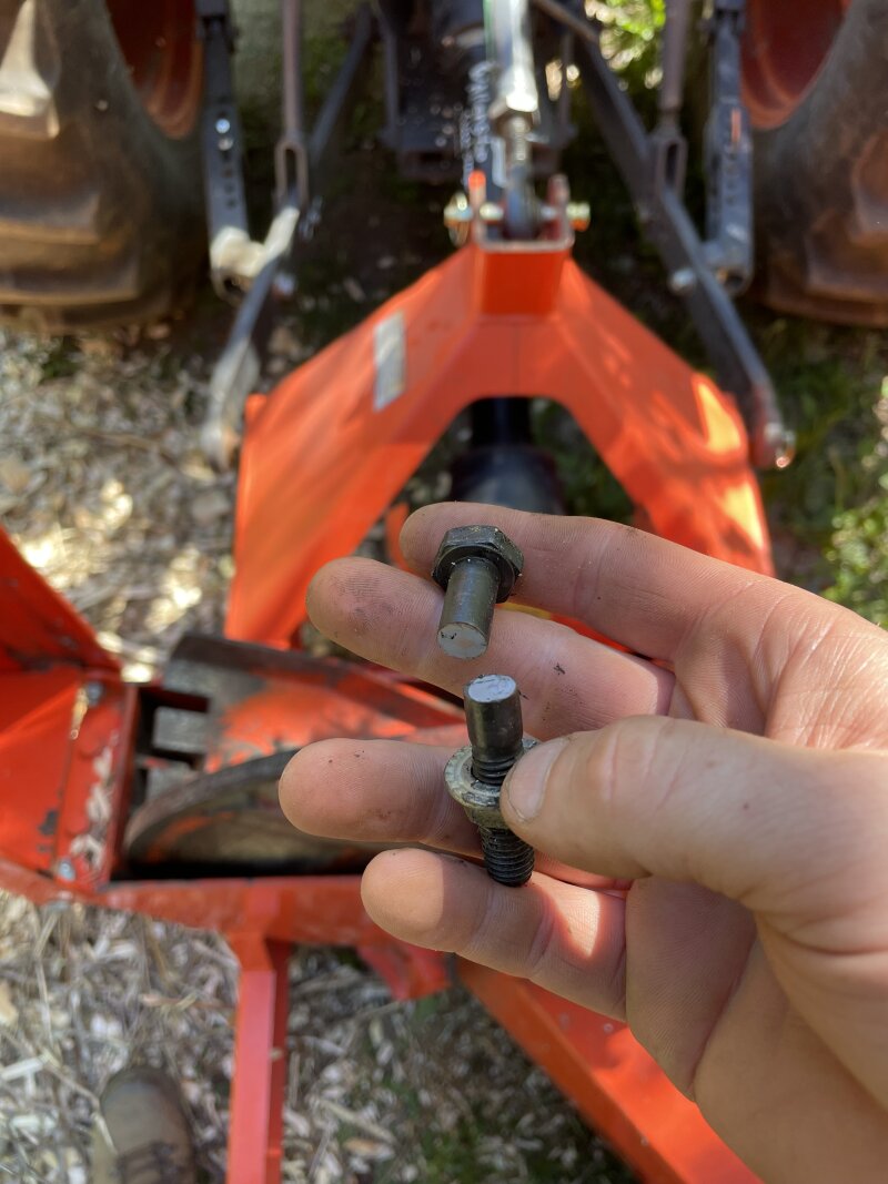 A bolt, broken in two, in my hand. It’s a shear pin from the wood chipper.