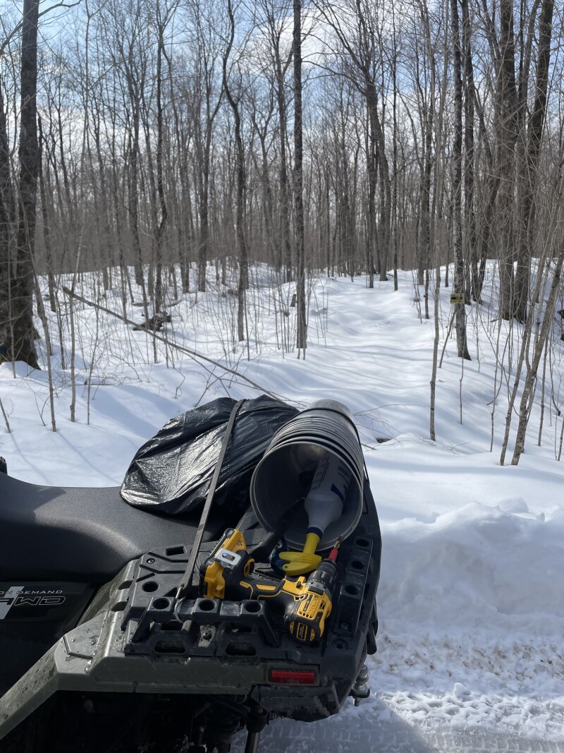 The back rack on the ATV loaded up with tapping supplies heading into the bush