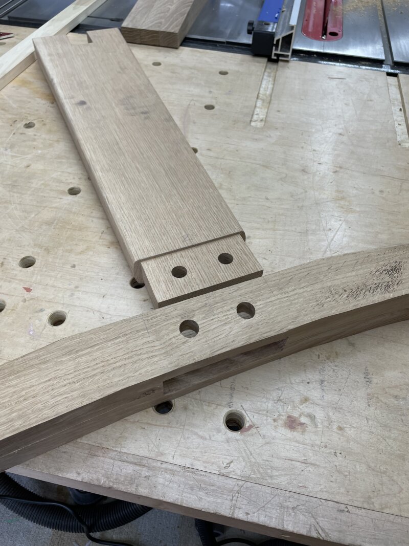 Two white oak furniture parts on my workbench, a table foot and leg, with an oversized mortice and tenon joint ready to press together.